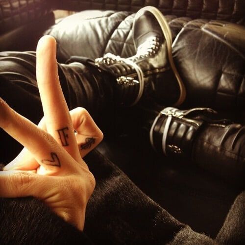 ‘♡’ (heart emoticon),  ‘F’ and  ‘$’ (dollar sign) - G Dragon tattoo